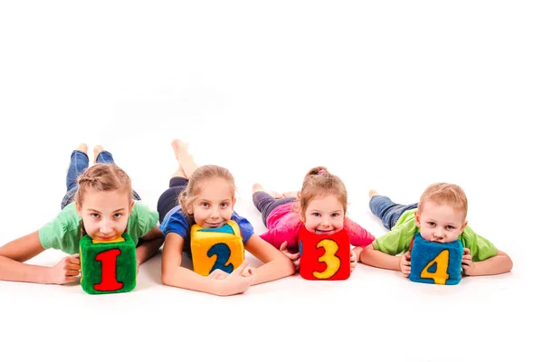 Crianças felizes segurando blocos com números sobre fundo branco — Fotografia de Stock