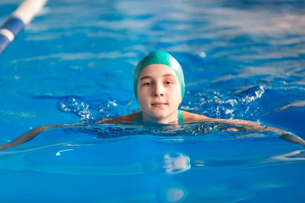 Cute little girl training in a swimming pool