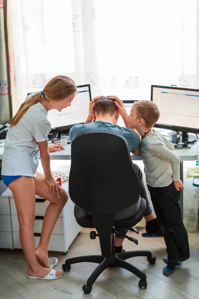 Father with kids trying to work from home during quarantine. Stay at home, work from home concept during coronavirus pandemic
