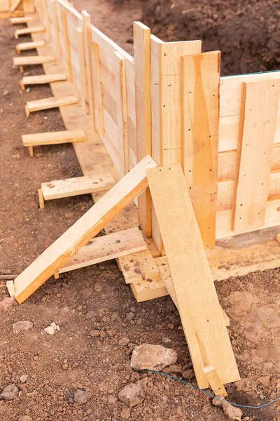 Wooden formwork for creating strip foundation for new house basis. Constructing house from the beginning concept — Stock Image Wooden Formwork Creating Strip Foundation New House Basis Constructing House Stock Picture