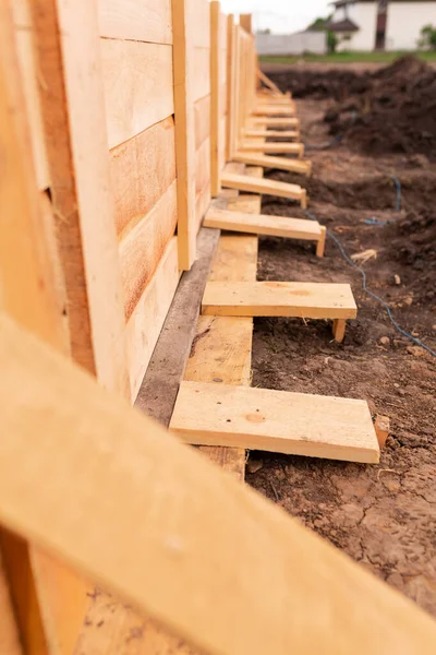 Wooden formwork for creating strip foundation for new house basis. Constructing house from the beginning concept — Stock Image Wooden Formwork Creating Strip Foundation New House Basis Constructing House Stock Picture