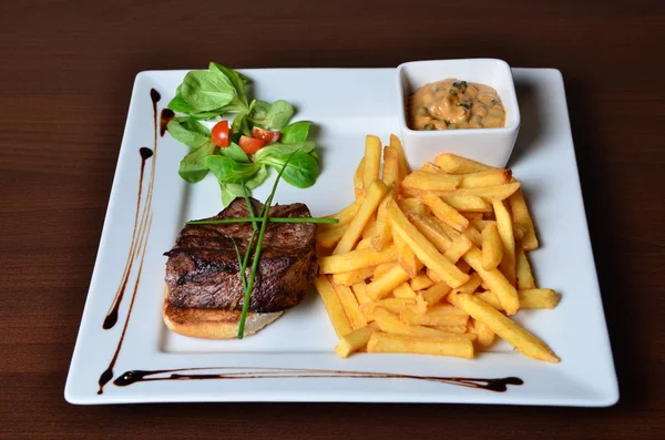 Steak with herbs and fries — Stock Photo, Image