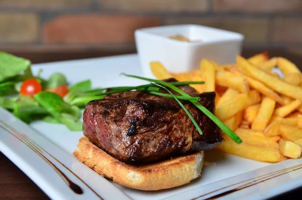 Steak with herbs and fries — Stock Photo, Image