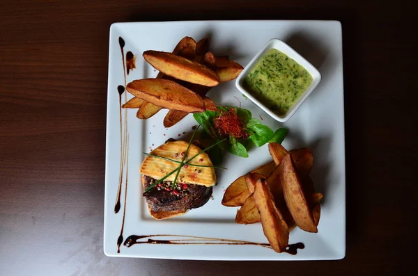 Steak with herbs and fries — Stock Photo, Image