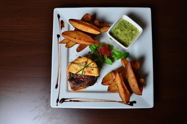 Steak with herbs and fries — Stock Photo, Image