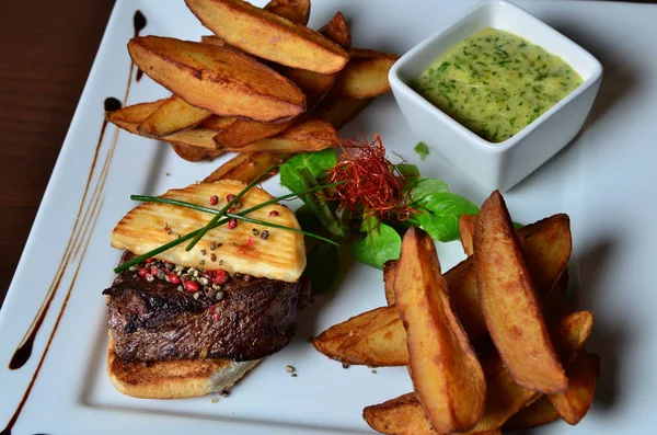 Steak with herbs and fries — Stock Photo, Image