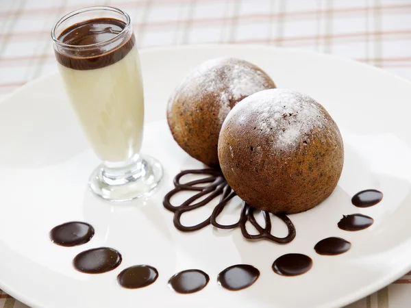 Deux gâteaux à l'éponge de type brownie fraîchement cuits avec sauce vanille — Photo