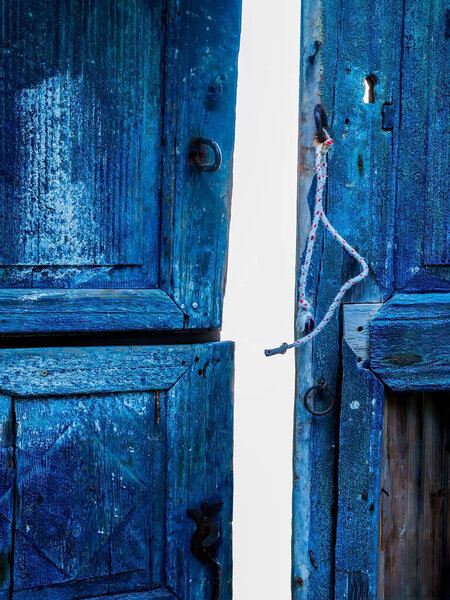 Old blue wooden door texture. Santorini, Cyclades, Greece.