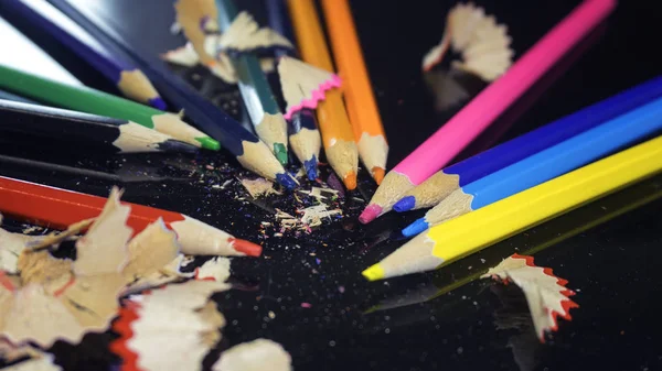 Renkli kalemler koyu arkaplanda izole bir şekilde kapatılır.