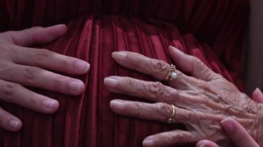 Büyükannenin eli, hamile torununun karnını tutuyor..