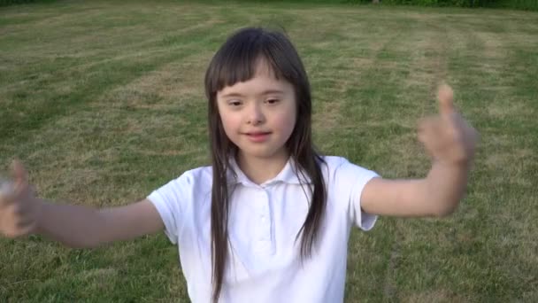 Down syndrome girl have fun outside — Stock Video