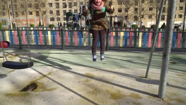 Little girl with down syndrome having fun on the swing — 비디오