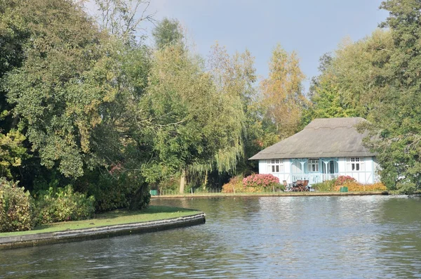 Bonita casa de campo ribeirinha do Reino Unido com grande rio em primeiro plano — Fotografia de Stock