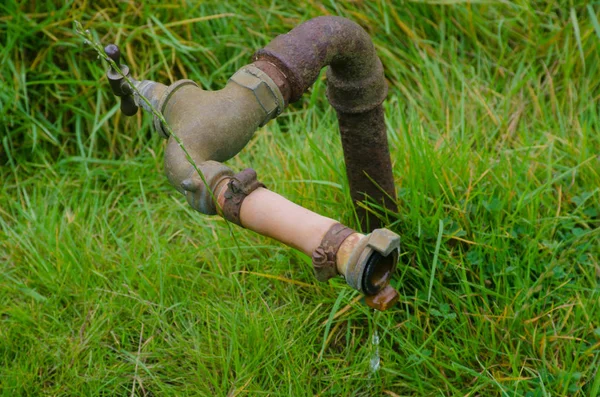 Vintage antique irrigation pipe on ground — Stock Photo, Image