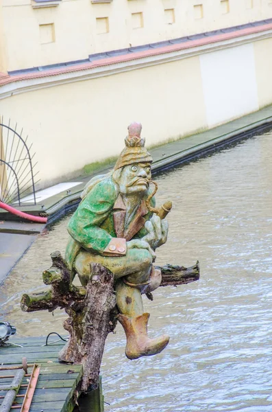 Statute of man Playing pipes over river in Prague