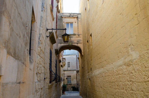 Back street in Mdina Malta with stone arch