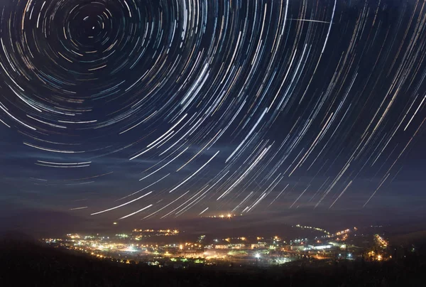 Startrails over the town — Stock Photo, Image