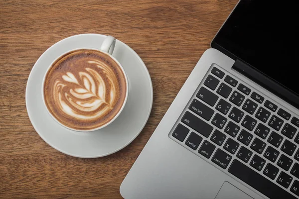 Koffie en laptop op het hout — Stockfoto