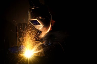 Fabrikadaki sanayi işçisi kaynaklarını kapatıyor.