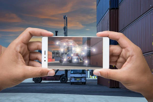 Hand holding smartphone is pressing button on touch screen inter — Stock Photo, Image