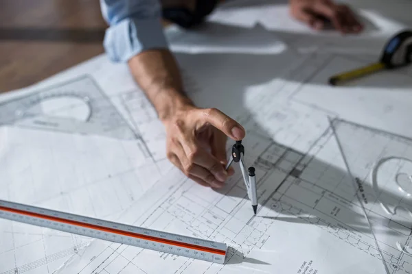 Architect working on blueprint.engineer inspective in workplace