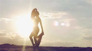 Gün batımında dans eden bir kadın silüeti