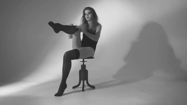 Beautiful woman dresses stockings. Black and white — Stock Video