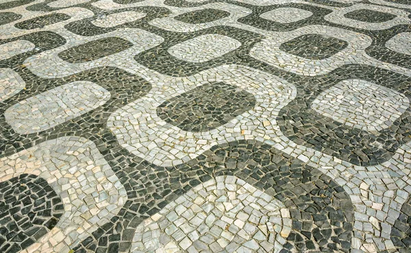 Black and white mosaic, Portuguese pavement by old design pattern at Ipan — Stock Photo, Image