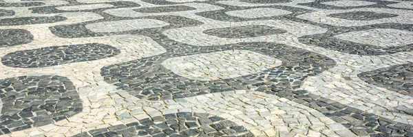 黑色和白色标志性马赛克，葡萄牙路面在里约热内卢伊帕内玛海滩的老设计模式。 — 图库照片