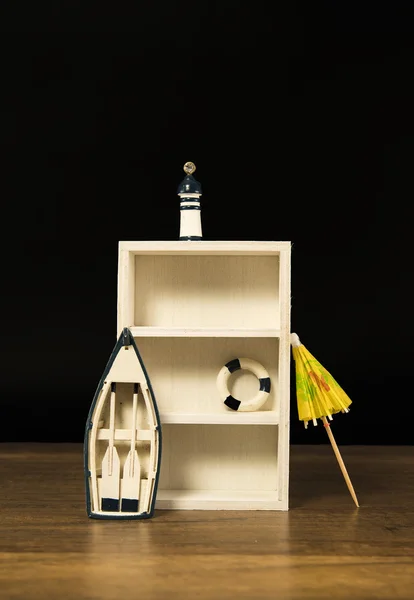 Leeres weißes Holzregal mit Boot, Leuchtturm und Rettungsring — Stockfoto