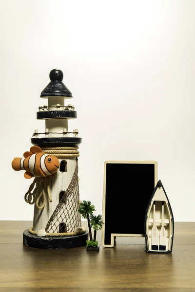 White Lighthouse with Crown fish and blank black board and boat