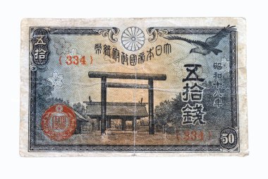 İçinde bir kapı, bir kuş ve tapınak resmi olan eski bir Japon banknotu.