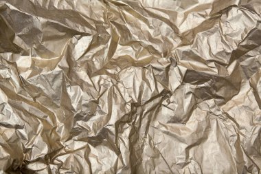 Altın soyut arka plan. Buruşuk doku metalik bir parıltıyla parlar.