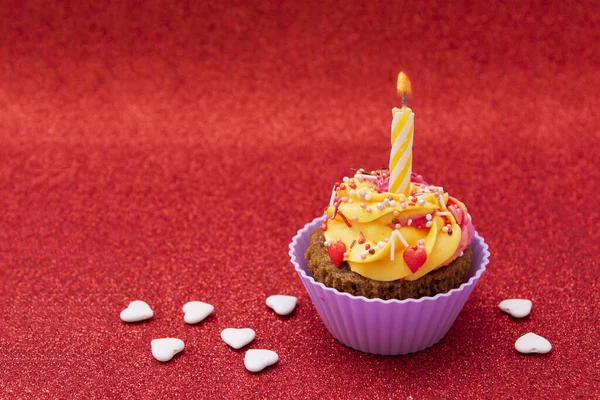 Cupcake Con Crema Una Vela Sobre Fondo Rojo —  Fotos de Stock