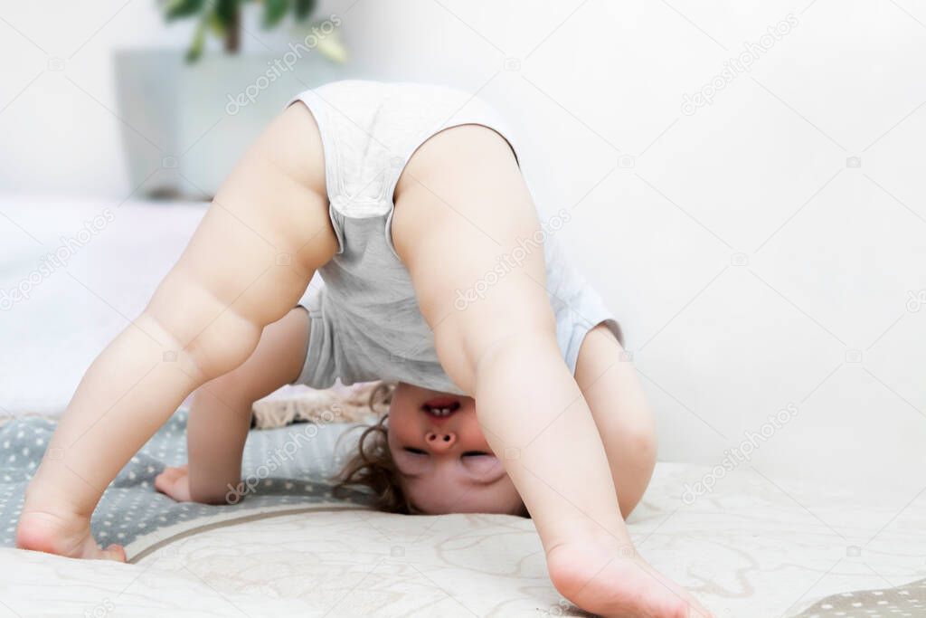 Funny kid upside down having fun at home