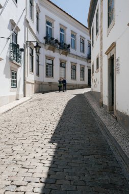 Faro - Portugal, April 3, 2018: Tourists taking picture near the Arch de Vila in the Old Town of Faro, Algarve, Portugal.  clipart