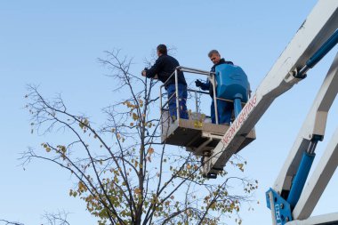 Cluj Napoca, Romania - 24 Oct, 2019: Workers installing a christmas light near the The Transfiguration Cathedral in Cluj Napoca, Romania. 