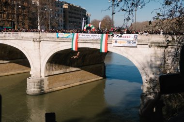 Rome, Italy - Jan 1, 2020: Giuseppe Palmulli  dives into the Tiber River from the 18 meter (59 feet) high Cavour Bridge in Rome