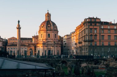 Rome, Italy - Jan 1, 2020: View across the ancient ruins of Trajan's Forum towards Trajan's Column and the Santa Maria di Loreto church in Rome, Italy