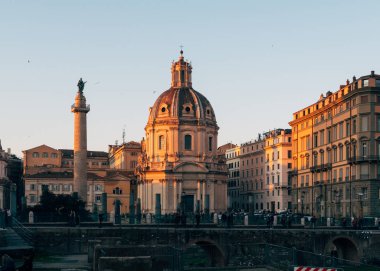 Rome, Italy - Jan 1, 2020: View across the ancient ruins of Trajan's Forum towards Trajan's Column and the Santa Maria di Loreto church in Rome, Italy