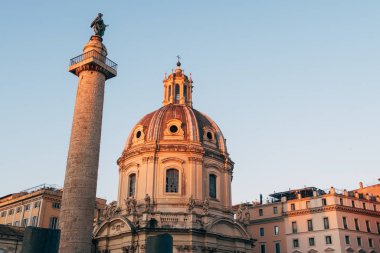 Rome, Italy - Jan 1, 2020: View across the ancient ruins of Trajan's Forum towards Trajan's Column and the Santa Maria di Loreto church in Rome, Italy