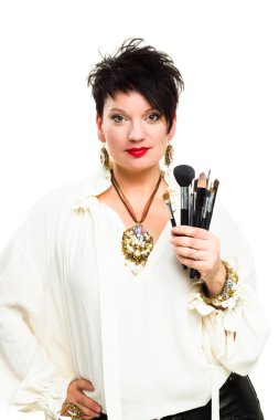 Attractive make-up artist with brushes on white background