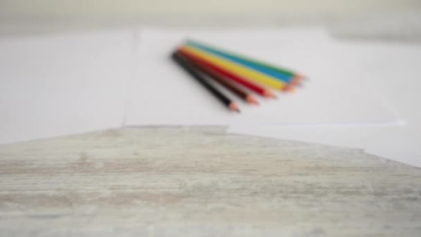 Colorful pencils isolated on paper — Stock Video