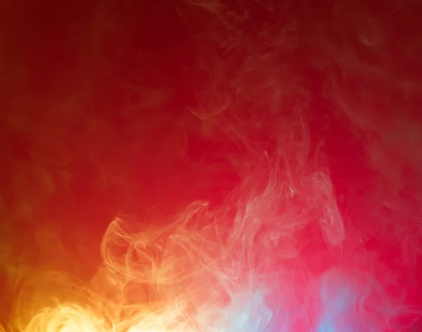 Yellow and blue smoke on red — Stock Photo, Image