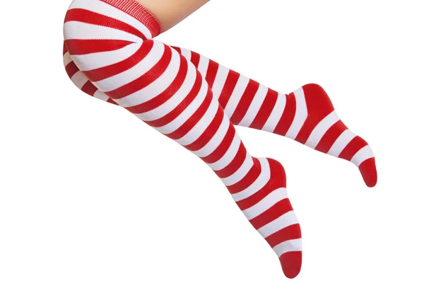 Beine in rot und weiß gestreiften Socken isoliert auf weißem Hintergrund — Stockfoto