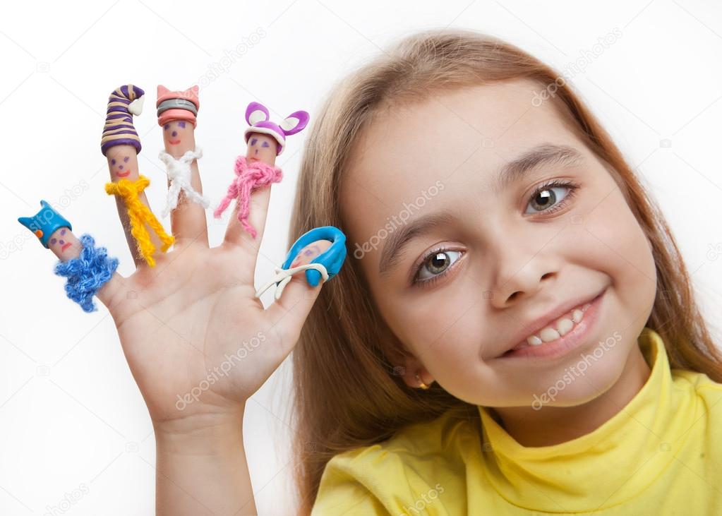 Happy girl with the painted men on the fingers in the clay caps and knitted scarves