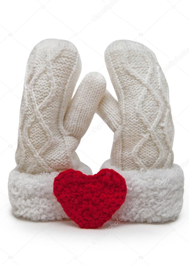 Soft couple. Knitted mittens with red heart.