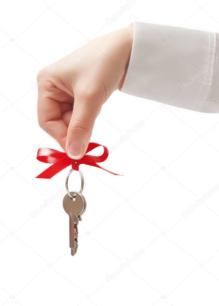 Hand holding key with bow isolated 