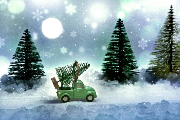 Christmas tree on the truck. Winter evening on the eve of the new year\'s fairy tale. Miniature.