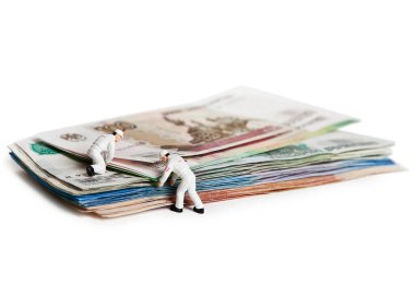 Doll people with Russian paper bills. Isolated on a white background.